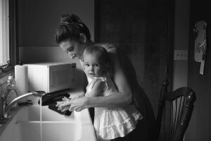 Co-parenting mama and baby washing hands