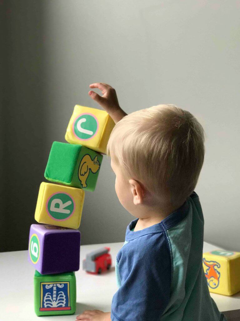 Small boy building a tower of blocks